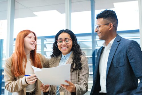 Young professionals converse in an office